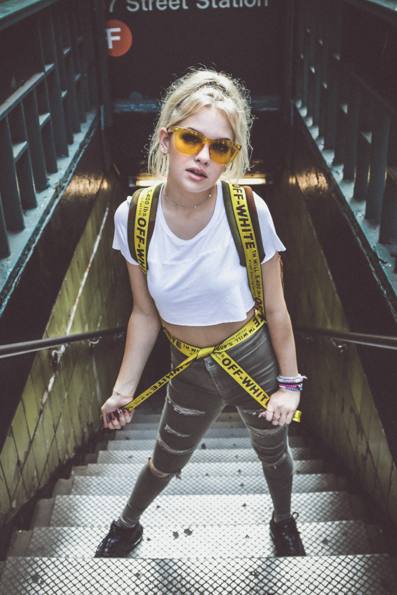 woman on stairs with branded clothing